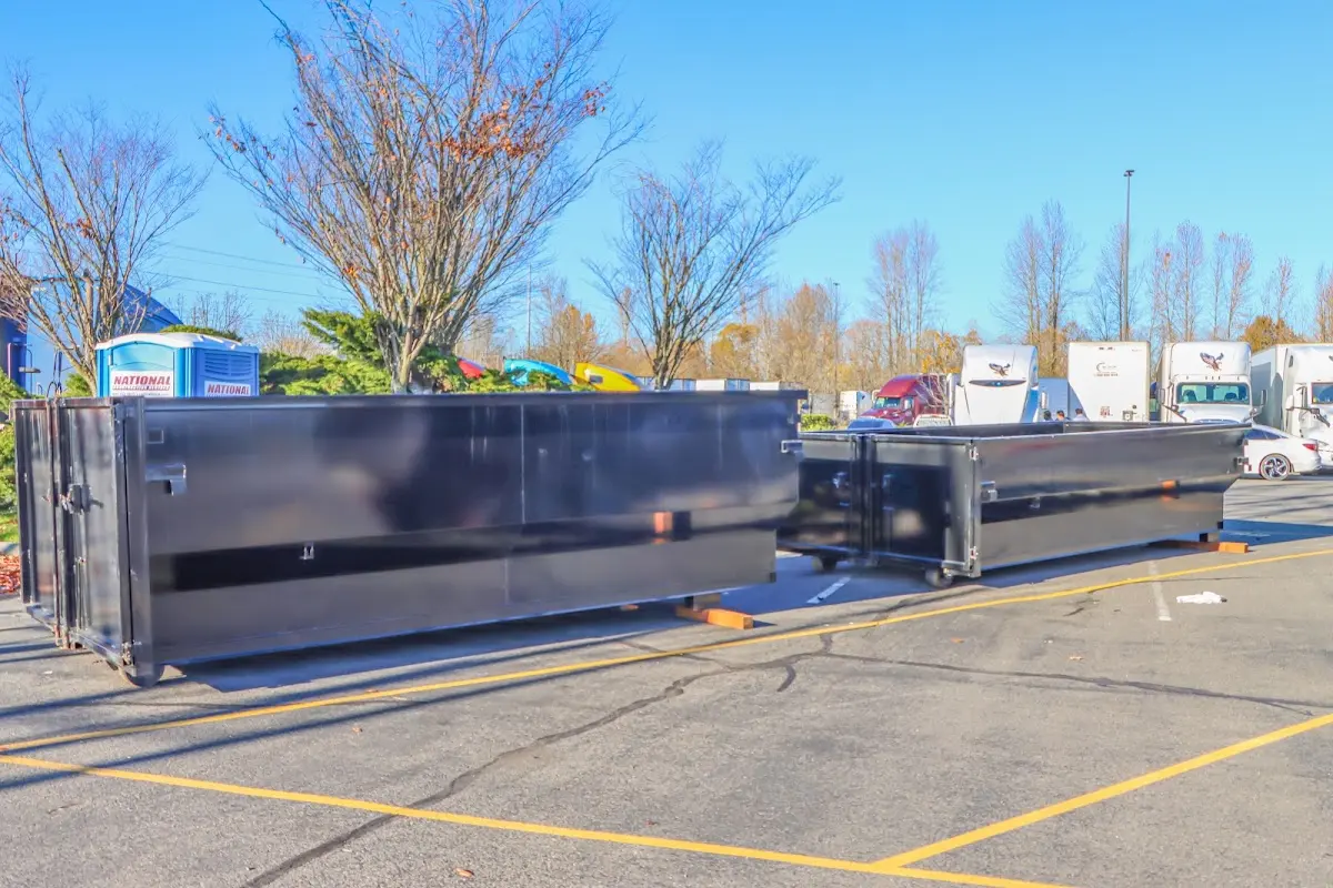 Professional dumpster rental service with roll-off container on residential driveway in Holly Springs